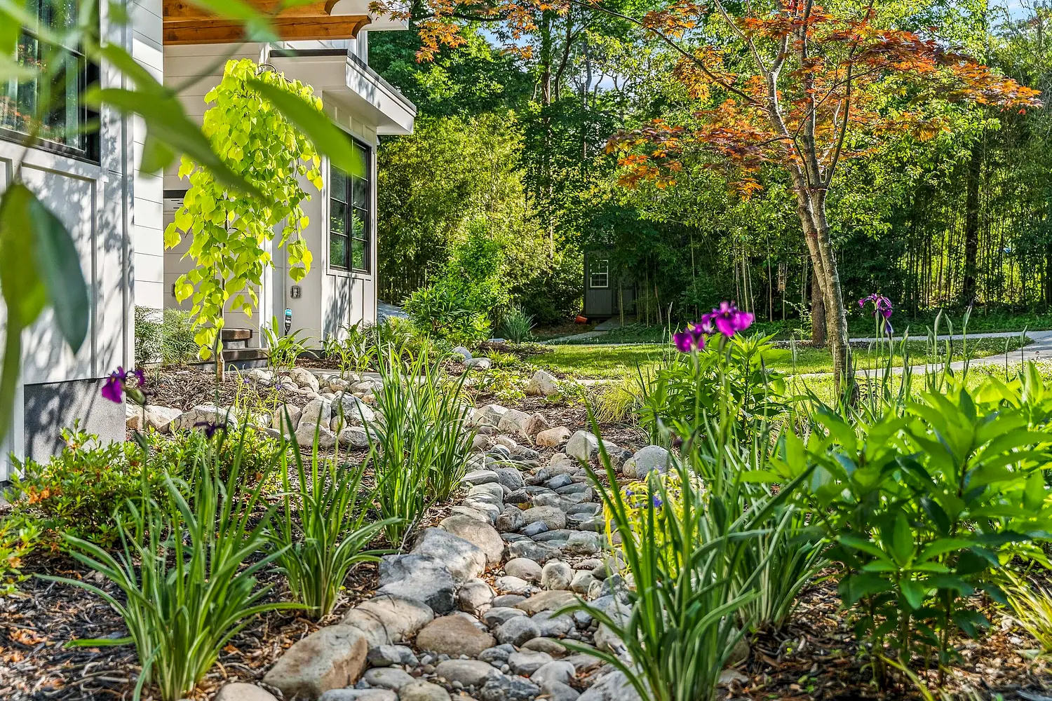 Layered garden planting and stone path by Southern Cut